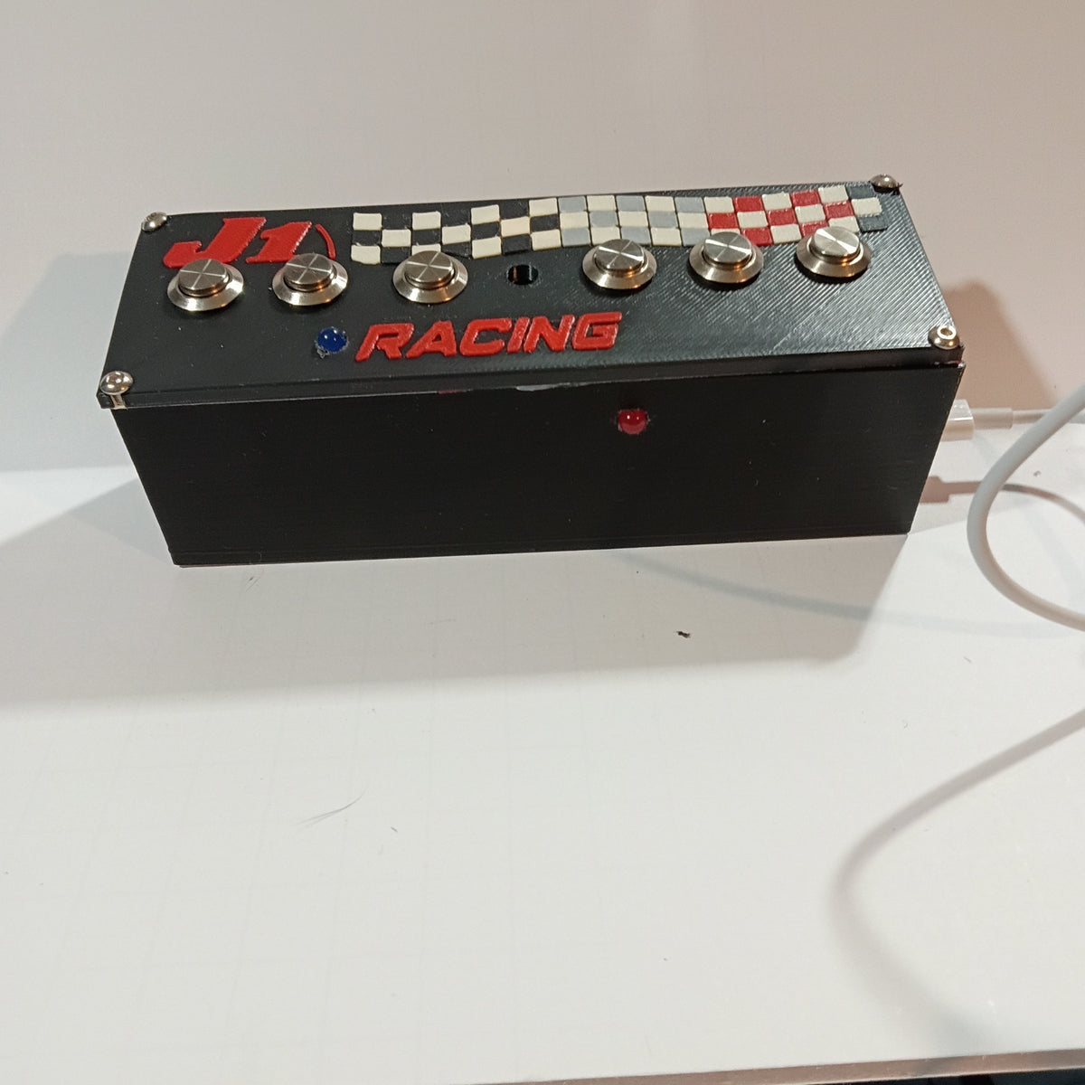 J1 S6.6B black USB button box on a white backdrop