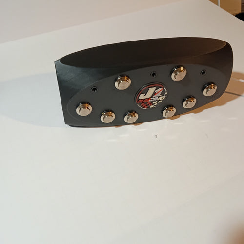 J1 black oval button box with eight silver metal buttons and center J1 badge